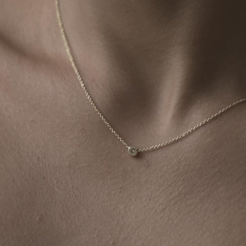 Solid gold and sterling silver jewellery: Video of a model wearing our signature 9ct yellow gold tiny letter G charm necklace on a 40cm cable chain