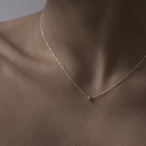 Solid gold and sterling silver jewellery: Close up video of a model wearing our signature 9ct yellow gold Tiny Letter I Charm Necklace on a 40cm cable chain